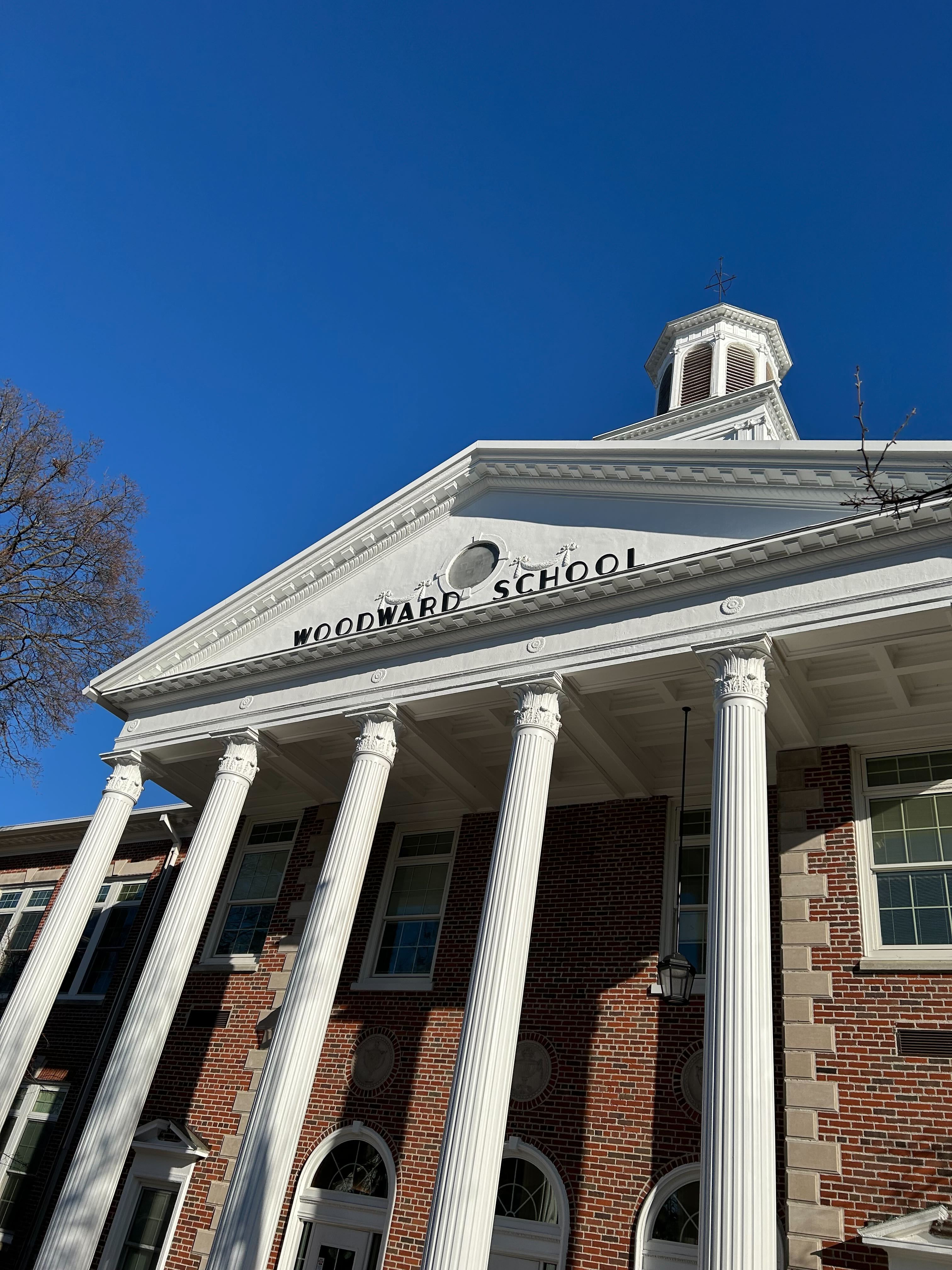Front of Woodward School with white pillars